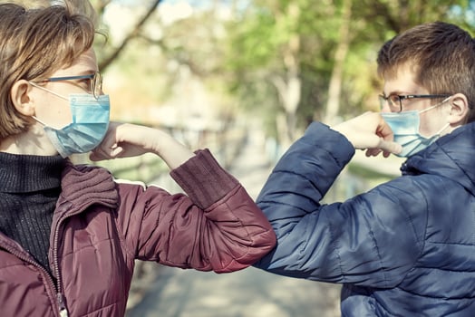 Friends guy and girl demonstrating a new way of greeting during coronavirus epidemic. photo