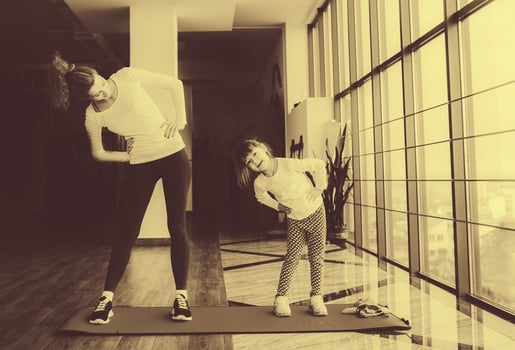 Two girls of different ages makeing yoga photo