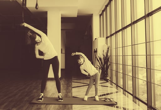 Two girls of different ages makeing yoga photo
