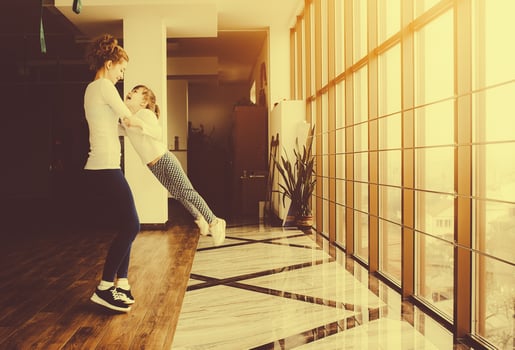 Mother twist her daughter in the gym photo