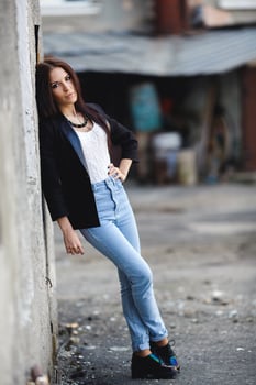 Beautiful female model posing against the wall photo