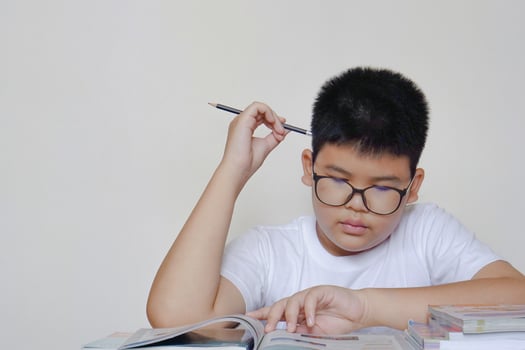Asian boy read a books and thinking. Creative, education, learning concept. photo