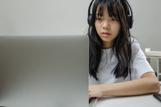 girl wearing headphones studying online with computer laptop and listen to relaxing music or play internet social media at home. photo