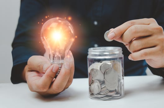 businessman is shown holding a jar with coins for savings and investments. Concept of tax payments and business accounting. photo