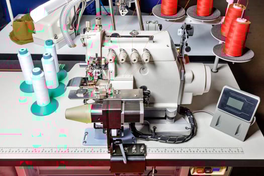 Overlocker and sewing machine as industrial equipment for light industry in a clothing factory. photo