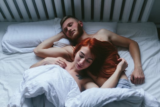 Young couple in bed together photo