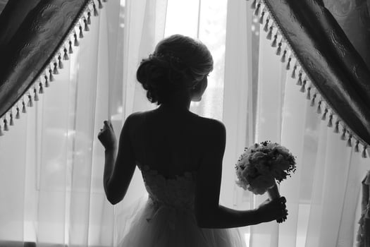 beautiful bride in a wedding dress, by window. photo