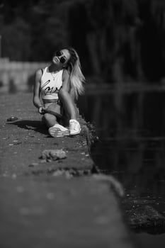 beautiful girl sitting on the pier photo