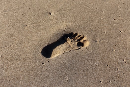 Footprints in the sand on the city beach. photo