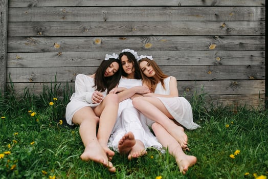 Three charming girls  near a wooden house photo