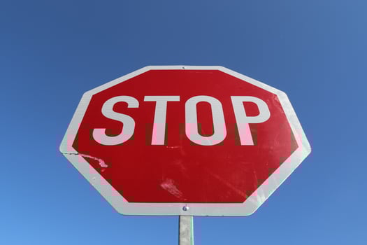 Stop sign against a clear blue sky. photo