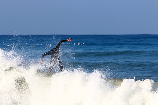 December 21, 2018 Israel. Surfing on high waves in the Mediterranean. photo