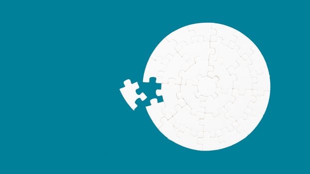 White part of jigsaw puzzle pieces on blue background. concepts of problem solving, business success, teamwork, Team playing jigsaw game incomplete, Texture photo with copy space for text