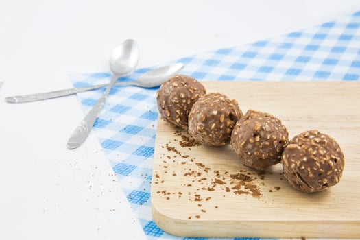 almond chocolate candy isolated on wood. concept photo