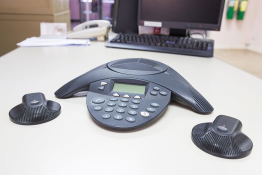 Conference IP phone on white table background photo