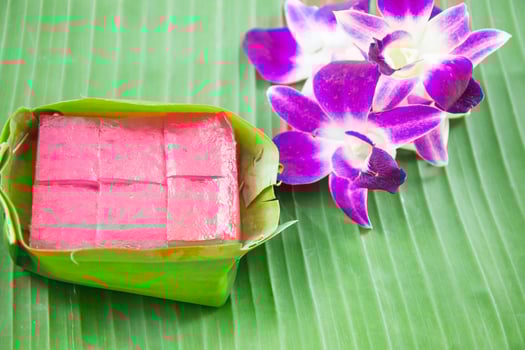 Kind of Thai sweetmeat, Multi Layer Sweet Cake Kanom Chan on banana leaf with orchid flower photo