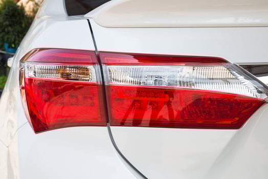Closeup of a taillight on a modern white car photo