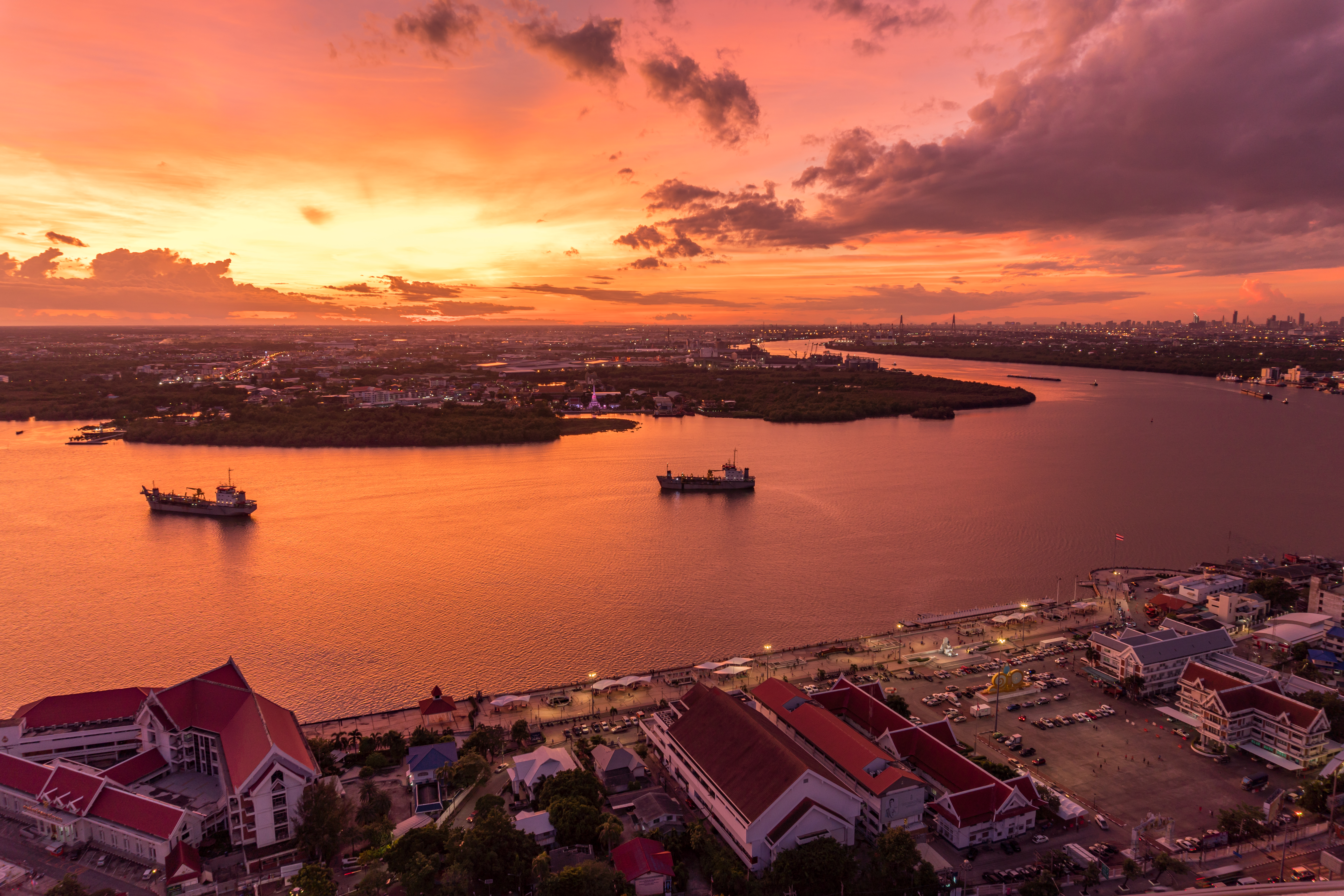 Bird's eye view of Samut Prakan, Thailand. Sunset over the Chao Phraya River, orange sky. photo