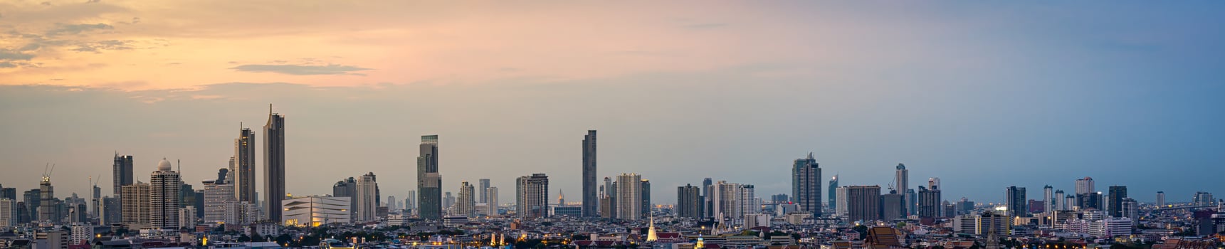 Panorama High rise office building The city centre of Bangkok. At dawn, the light from the sky is orange. photo