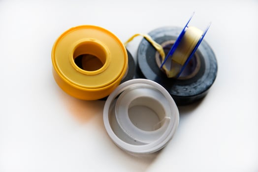 Rolls of duct tape and household putty on a white background. Insulating tape for dielectric processing, installation, repair. photo