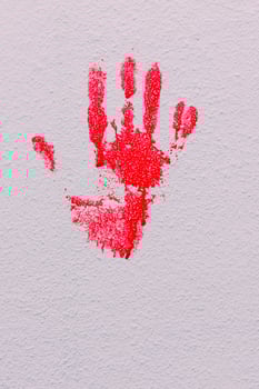 Bloody print of a bleeding hand on a white background photo