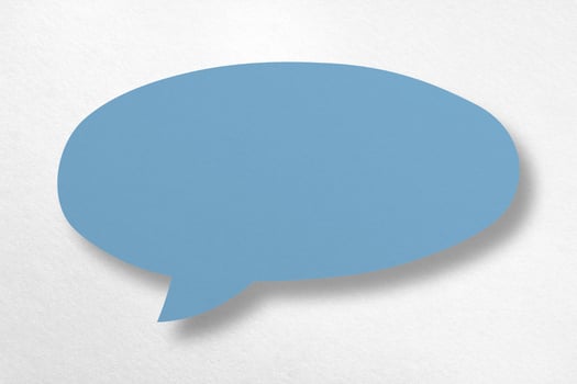 Speech balloon shaped blue paper isolated on white background. photo
