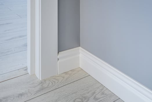 Detail of corner flooring with intricate crown molding and plinth. photo
