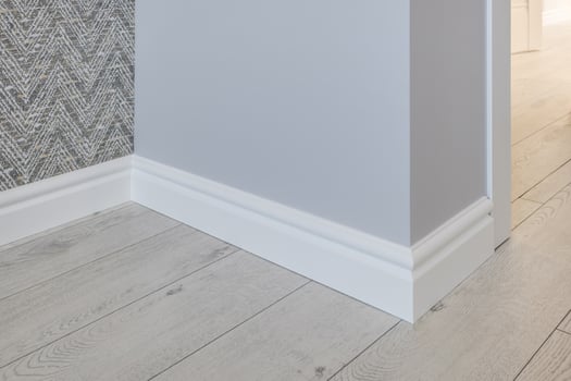 Detail of corner flooring with intricate crown molding and plinth. photo