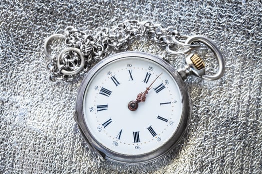 antique pocket watch on silver fabric background photo