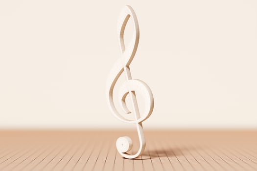 Realistic beige metal treble clef on a monochrome  background. 3d golden musical symbol - decoration elements for design. photo