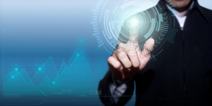 Financial stock trading graph. Businessman touching a technology concept on a touch screen with finger photo