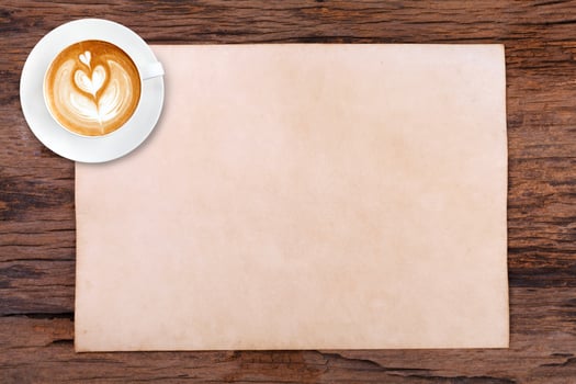 Cup of coffee and paper texture on wooden photo