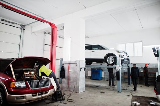 American SUV car vehicle repair shop with car and tools. Car service. photo