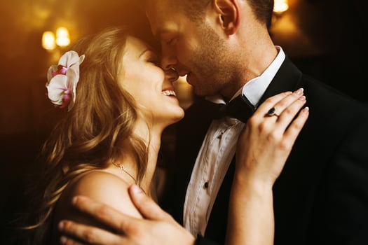 The bride and groom in a cozy house, photo taken with natural light from the window.