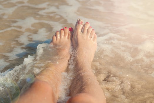 girl legs in sea photo