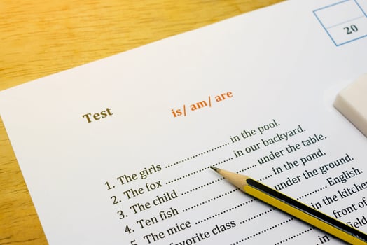 english test on brown wooden desk with gradient light photo