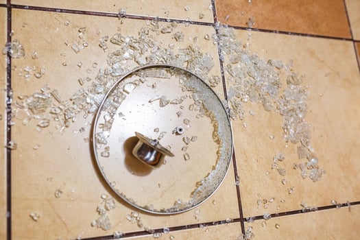 Broken glass lid on the ceramic tiles floor. Family quarrel. Irritation. broken dishes for happiness photo