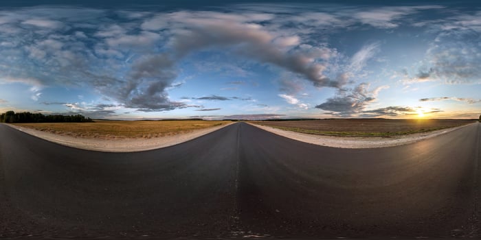 full seamless spherical panorama 360 degrees angle view on asphalt road among fields in summer evening sunset with awesome clouds in equirectangular projection, skybox VR AR virtual reality content photo