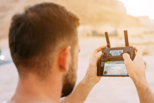 Guy controls drone with remote control photo