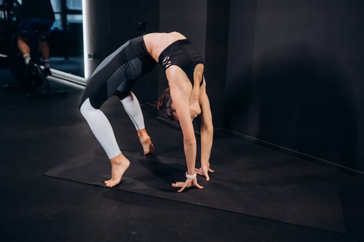 Slim athletic woman doing exercise bridge at gym photo