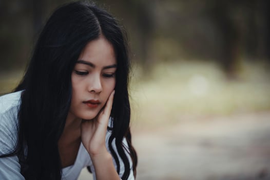 Beautiful thai woman very sad from unrequited love,She rethink and think over about love,vintage style,dark tone,broken heart,asian girl photo