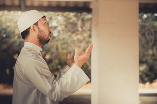 Young asian muslim man praying on sunset,Ramadan festival concept photo