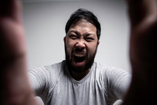 Portrait of Asian young man on white background,Angry man concept photo