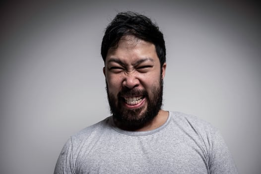 Portrait of Asian young man on white background,Angry man concept photo