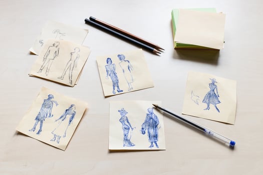 sketches of fashionable silhouette on light table photo