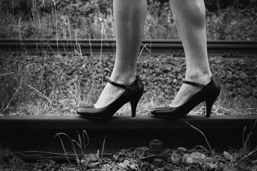 Woman with high heels on a railway track photo