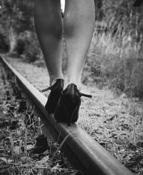 Woman with high heels on a railway track photo