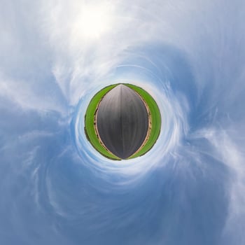 Little planet transformation of spherical panorama 360 degrees. Spherical abstract aerial view in field with awesome beautiful clouds. Curvature of space. photo