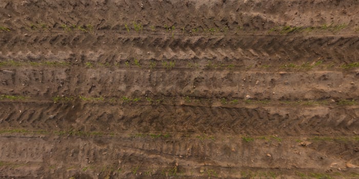 view from above on texture of gravel road with car tire tracks photo