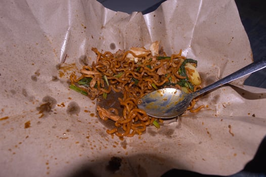 Fried noodles sold on the side of the road in Indonesia. food wrapping paper. photo